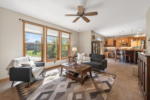 The family room is bathed in natural light through its south-facing windows, while heated tile floors add a cozy warmth underfoot.