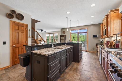 Storage and organization are built right in, with custom cabinetry featuring 42" uppers, specialized drawers for cooking tools and cutting boards, and thoughtful design details that make this kitchen as functional as it is beautiful.