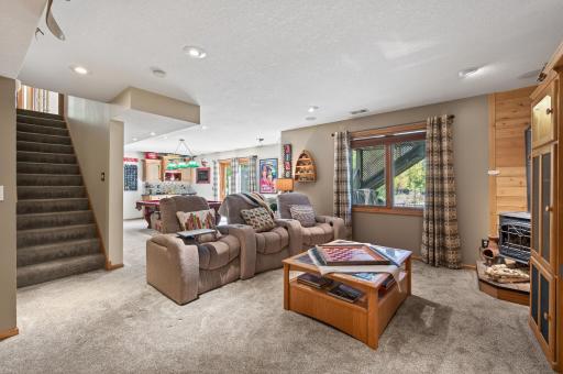 Head downstairs to the lower-level family room, where a cozy fireplace and newer carpet create the perfect setting for movie nights and relaxing evenings. With room for a large TV and theater seating, this is your go-to entertainment destination.