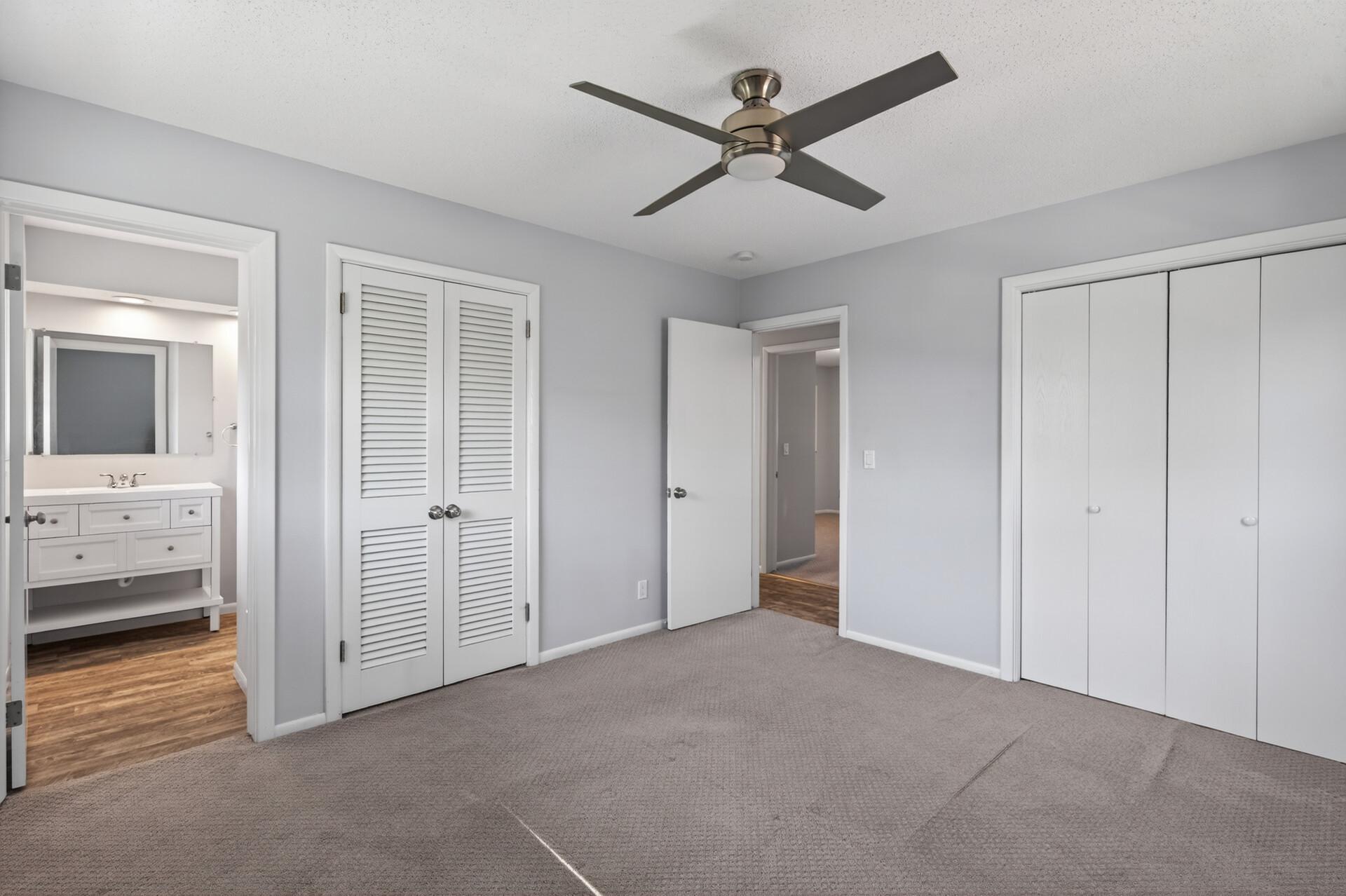 Neutral primary bedroom with 1/2 ensuite