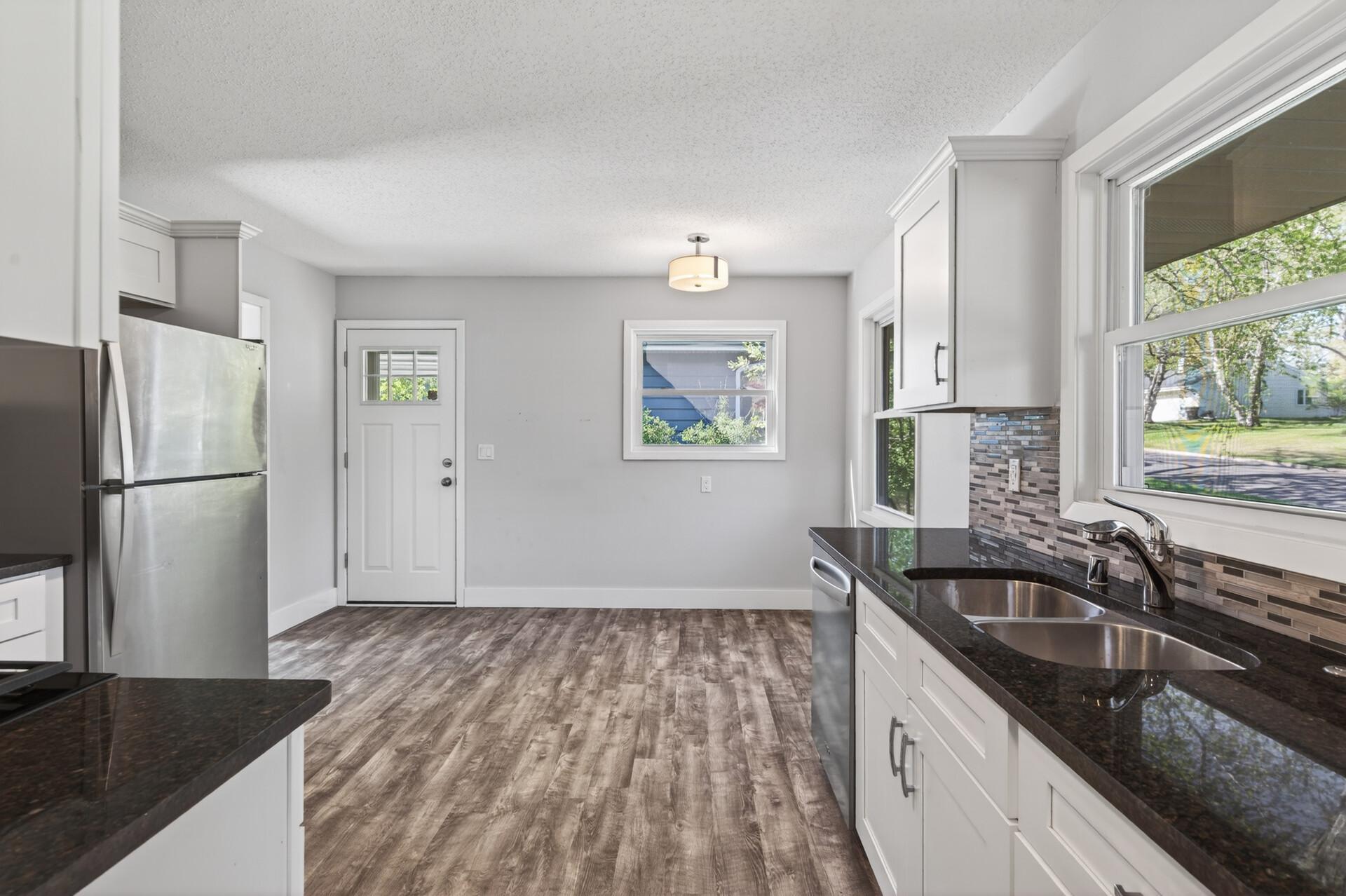 Recently bright and airy updated kitchen with granite counters, SS appliances and windows galore!