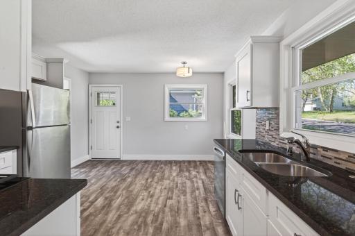 Recently bright and airy updated kitchen with granite counters, SS appliances and windows galore!
