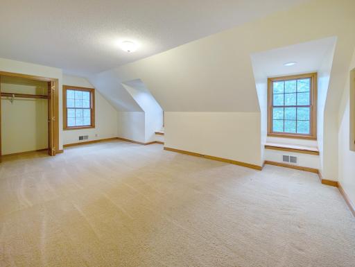 Charming upper bedroom with dormered windows.