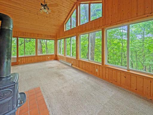 Vaulted 4 season porch with a gas stove offers vista views.