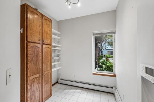 South facing kitchen nook with pantry cabinet and view of coutyard.