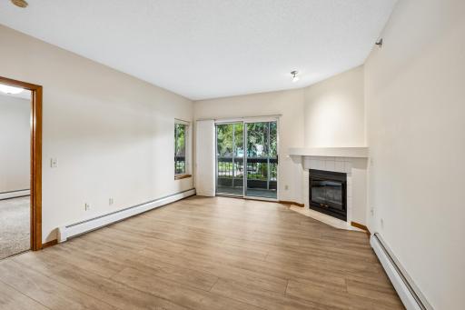 Living room with gas fireplace and walk out to screen porch.