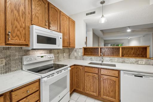 Kitchen with custom cabinetry and tile backsplash.