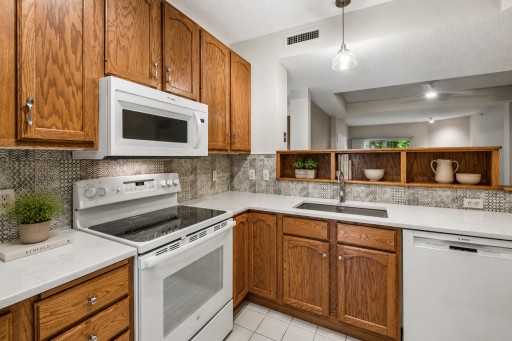 Kitchen with custom cabinetry and tile backsplash virtually staged.