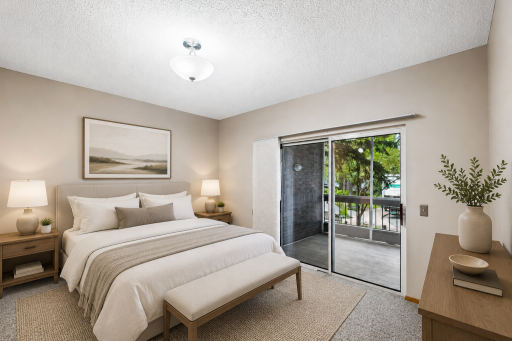 Primary bedroom ensuite with sliding door access to screen porch virtually staged.