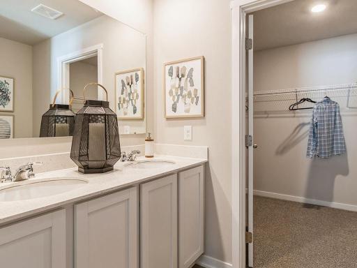 The ensuite bathroom features a double sink and walk-in shower.