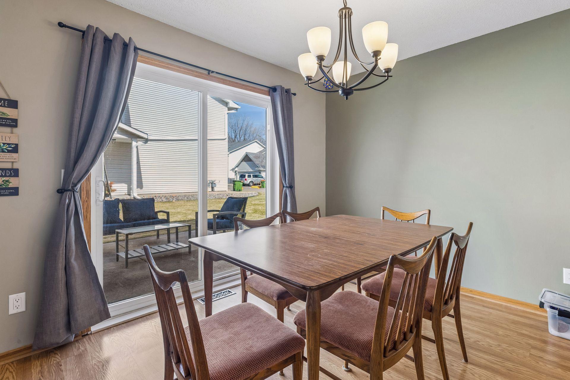 Charming casual dining area off the kitchen, complete with Pergo flooring, overhead lighting, and sliding glass doors leading to the patio.