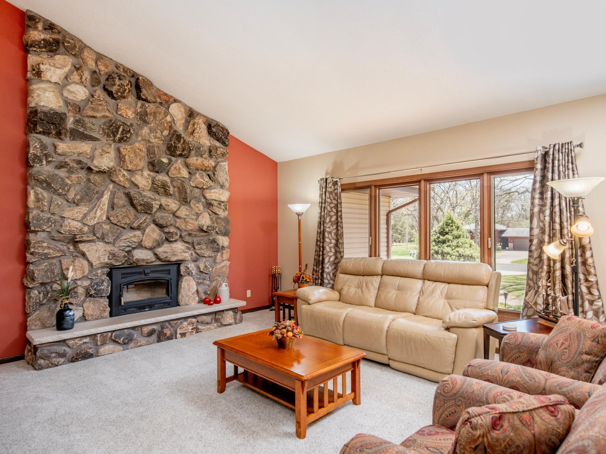 The well lit living room with vaulted ceiling is bright & inviting.