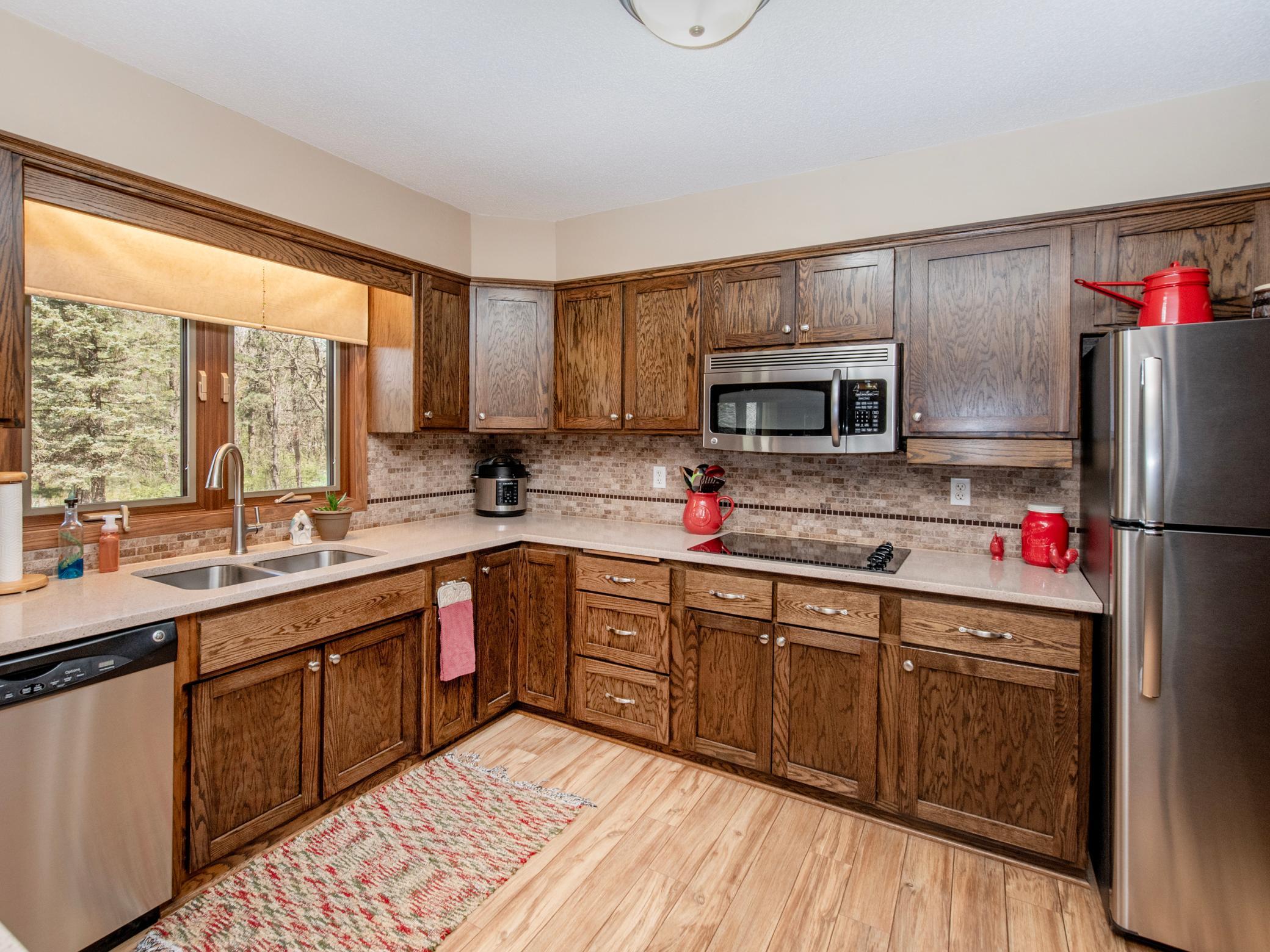The Kitchen is flooding with natural light with this large window. The stainless steel appliances; refrigerator, cooktop and microwave make for a cook's delight.