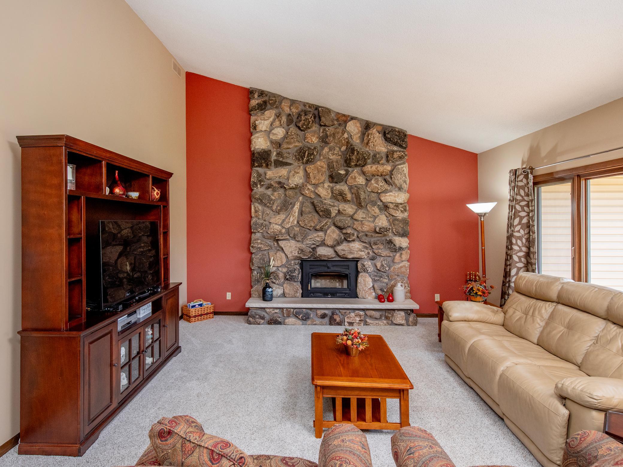 The floor-to-ceiling stone front wood-burning fireplace makes for a perfect place to curl up with a book or entertain friend.