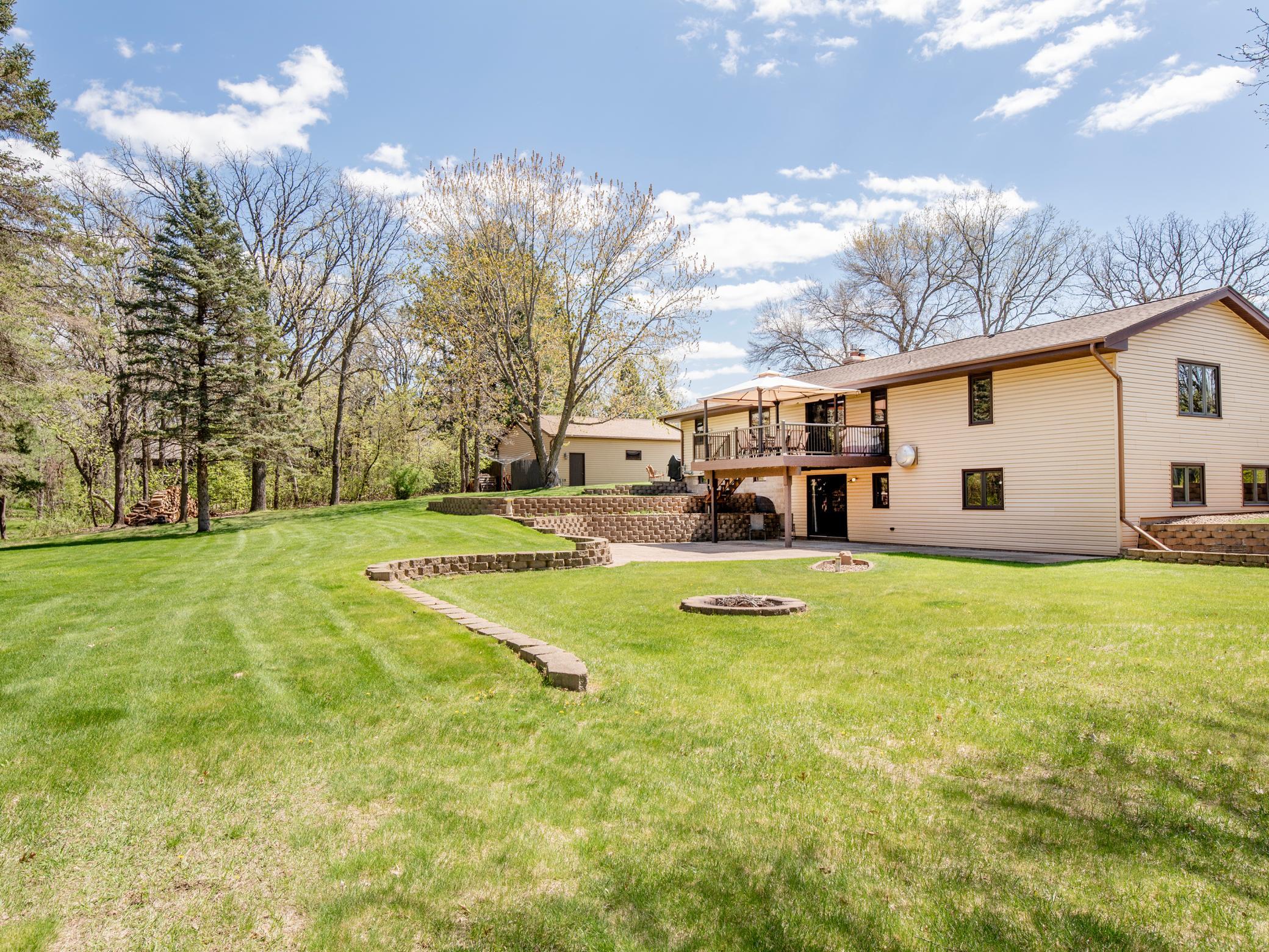 Landscaping with perennials in terraced area, & mature trees in the distance. Amazing!
