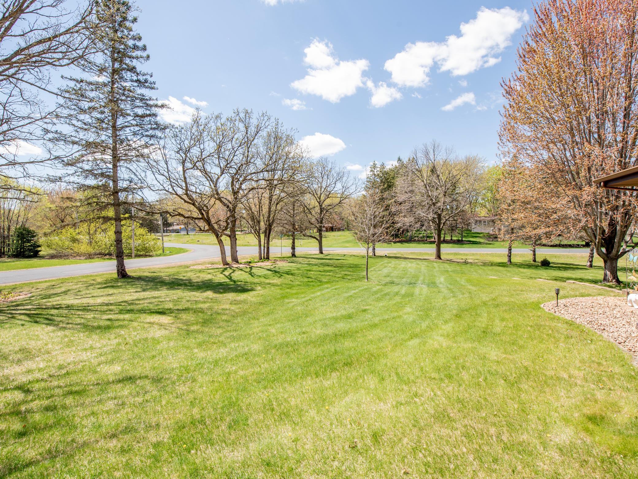 With the front yard leading to the side yard along with several trees lining the street it makes for a lovely view!
