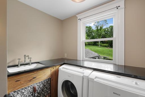 In addition to the primary ensuite, the upper level boasts a full laundry room, two additional bathrooms and four generously sized bedrooms.