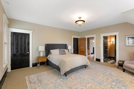 Unwind at the end of the day in the luxurious primary ensuite featuring his and her walk-in closets, a private bathroom with heated tile floors, dual vanities, a freestanding soaking tub, a walk-in shower, and a separate water closet.