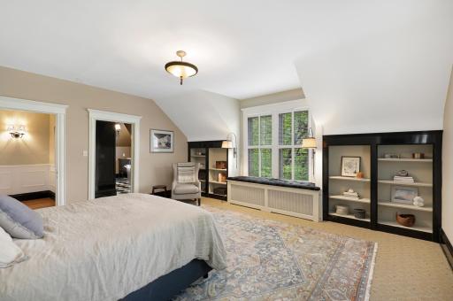 Unwind at the end of the day in the luxurious primary ensuite featuring his and her walk-in closets, a private bathroom with heated tile floors, dual vanities, a freestanding soaking tub, a walk-in shower, and a separate water closet.