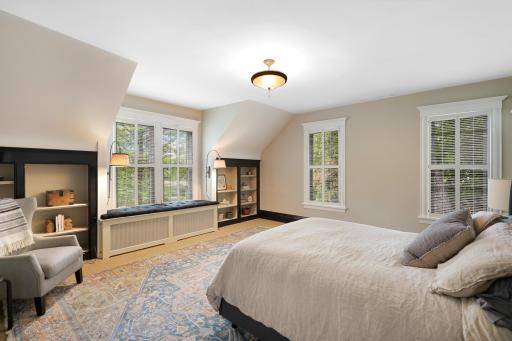 Unwind at the end of the day in the luxurious primary ensuite featuring his and her walk-in closets, a private bathroom with heated tile floors, dual vanities, a freestanding soaking tub, a walk-in shower, and a separate water closet.