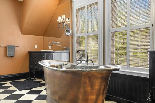 Unwind at the end of the day in the luxurious primary ensuite featuring his and her walk-in closets, a private bathroom with heated tile floors, dual vanities, a freestanding soaking tub, a walk-in shower, and a separate water closet.