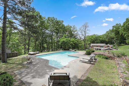 An inground pool area at the SE corner with patios and an outdoor fireplace provides an excellent space to relax and enjoy nature or entertain friends and family.
