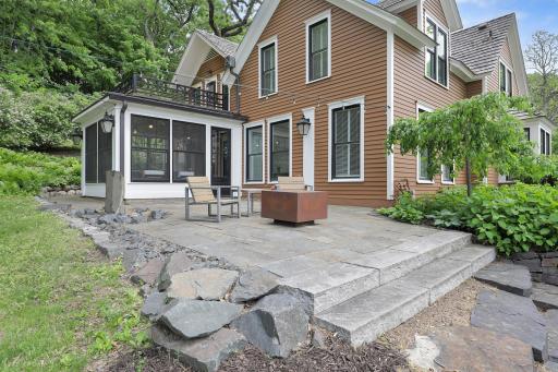 Updated landscaping, patios, and retaining walls surround the home.