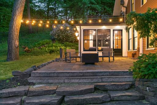 Updated landscaping, patios, and retaining walls surround the home.