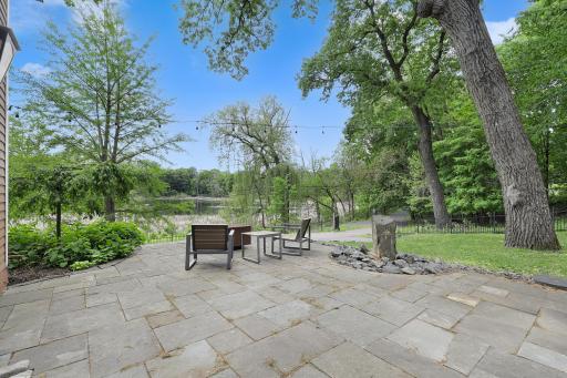 Updated landscaping, patios, and retaining walls surround the home.