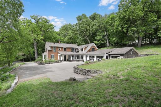 An inground pool area at the SE corner with patios and an outdoor fireplace provides an excellent space to relax and enjoy nature or entertain friends and family.