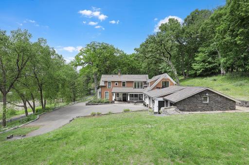 An inground pool area at the SE corner with patios and an outdoor fireplace provides an excellent space to relax and enjoy nature or entertain friends and family.