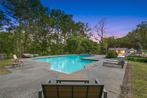 An inground pool area at the SE corner with patios and an outdoor fireplace provides an excellent space to relax and enjoy nature or entertain friends and family.