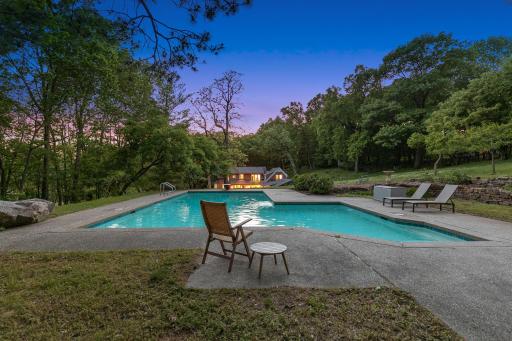 An inground pool area at the SE corner with patios and an outdoor fireplace provides an excellent space to relax and enjoy nature or entertain friends and family.