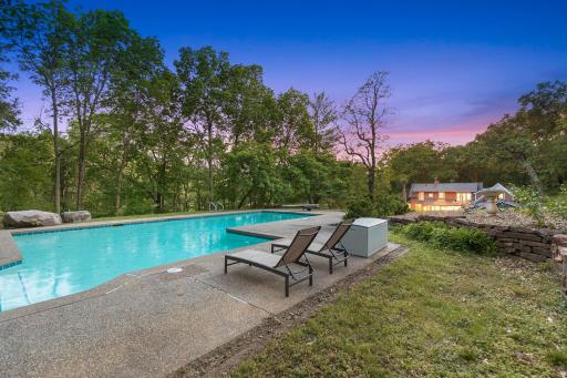 An inground pool area at the SE corner with patios and an outdoor fireplace provides an excellent space to relax and enjoy nature or entertain friends and family.