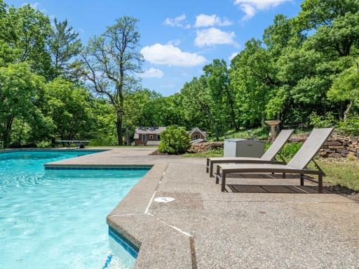 An inground pool area at the SE corner with patios and an outdoor fireplace provides an excellent space to relax and enjoy nature or entertain friends and family.