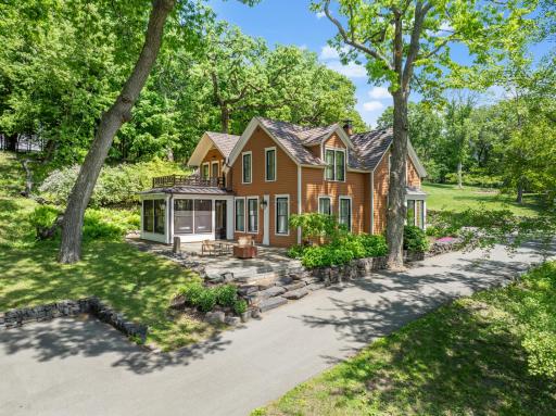 Updated landscaping, patios, and retaining walls surround the home.