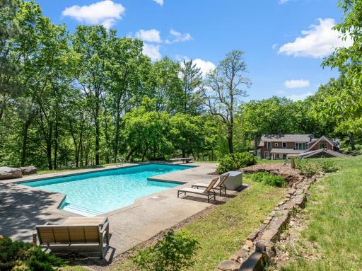 An inground pool area at the SE corner with patios and an outdoor fireplace provides an excellent space to relax and enjoy nature or entertain friends and family.