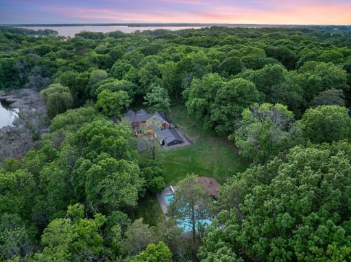 The fully fenced, maturely wooded, resort like estate provides nearly 360 degrees of privacy and ample space for endless outdoor activities.