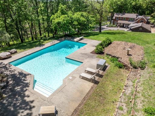 An inground pool area at the SE corner with patios and an outdoor fireplace provides an excellent space to relax and enjoy nature or entertain friends and family.