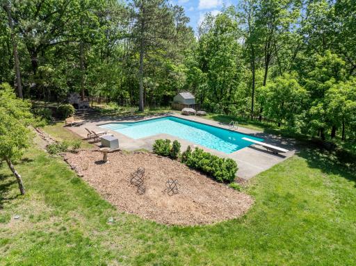 An inground pool area at the SE corner with patios and an outdoor fireplace provides an excellent space to relax and enjoy nature or entertain friends and family.