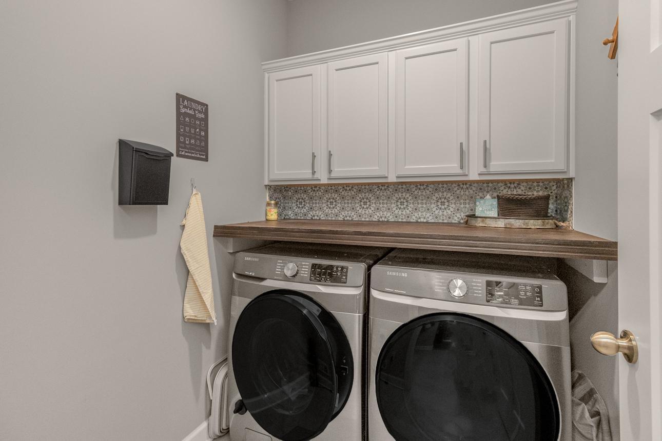 Laundry with convenient storage cabinets & countertop