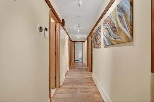 Extra wide hall to two main level bedrooms, a full bathroom, a bunch of closets, garage access, and staircase to finished walkout lower level!