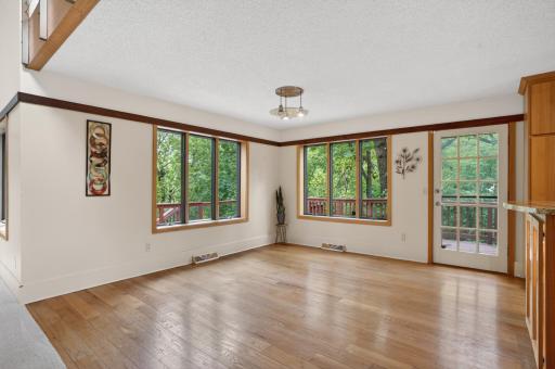 Main level dining connects to huge kitchen and walks out to a multilevel deck. Set among the tree tops, you can grow right outside your kitchen door!