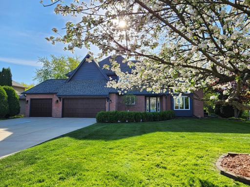 Beautiful landscaping throughout, and many recent improvements including: west-facing concrete driveway, newer garage doors, roof (2025), Leaf Guard gutters (2025), exterior painted (2025), A/C (2025), and the windows were replaced (2020).