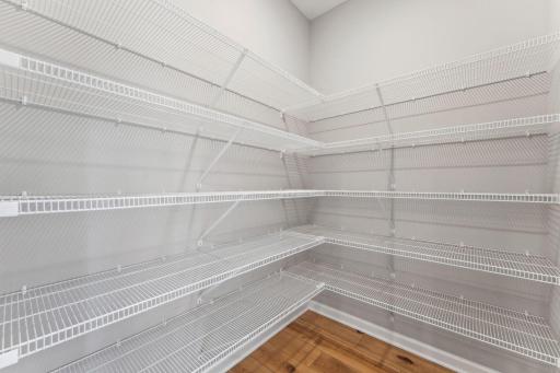 Huge walk-in pantry with abundant shelving for organized storage and easy access to everyday essentials. Similar home shown, options can vary.