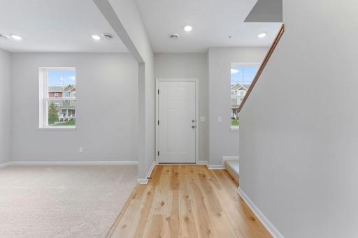 Entry way leads to the adjacent rec room or continue up to the main level. Similar home shown, options can vary.