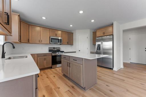 Photo of similar home for reference only. Colors and selections will vary. Kingston floorplan. Microwave vents to exterior! Stylish tile backsplash! Walk-in pantry!