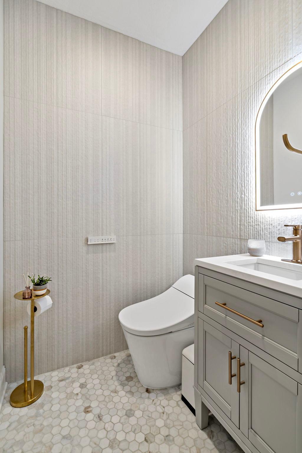 Newly remodeled main floor bathroom, gorgeous wall and floor tile and premium Japanese-style bidet toilet