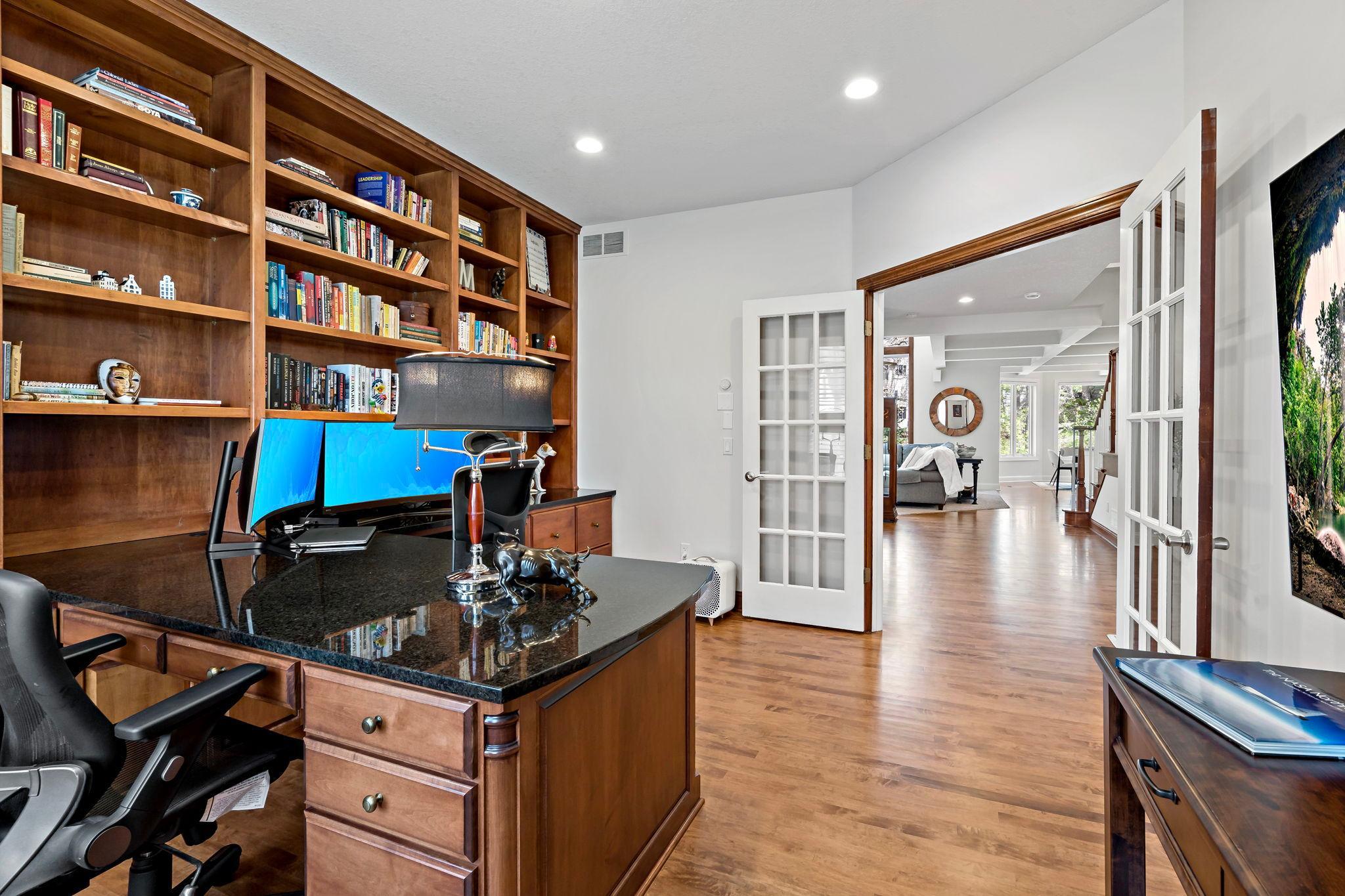 Incredible and spacious office in the front of the home with wonderful built-ins and gorgeous French doors