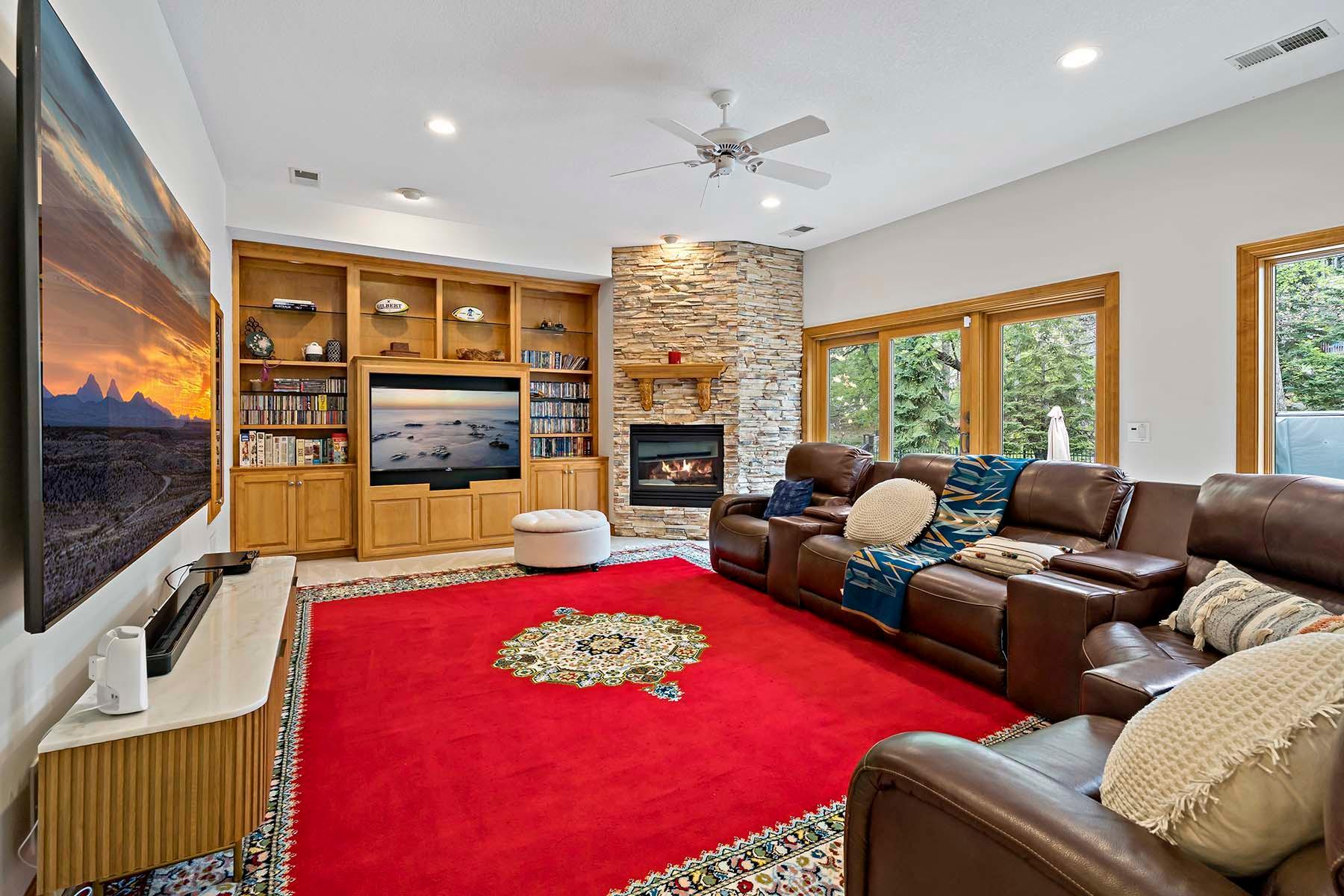 Amazing lower level family room with beautiful views of the backyard! Gorgeous stone fireplace and built-ins.